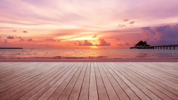 Photo of Wooden walkway beside sunset beach