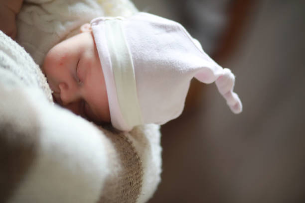 istock Baby newborn sleeping wrapped up in a blanket 1184382311