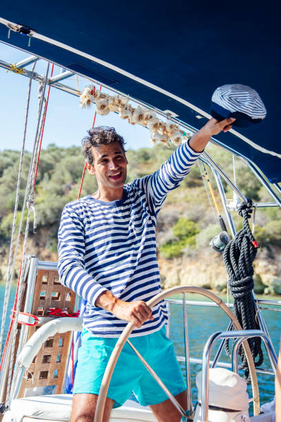 istock Handsome young man on a sailboat 1184383581