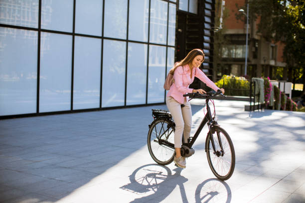 istock Young woman riding an electric bicycle 1184383706