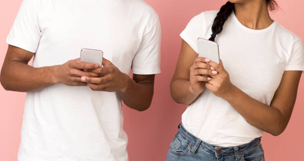 istock Young couple using phones and discussing new application 1184385928