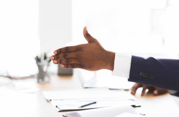 istock Cropped image of african investor extending his hand 1184385981