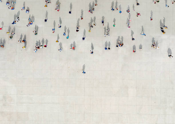 istock Man standing out of a Crowd 1184386124