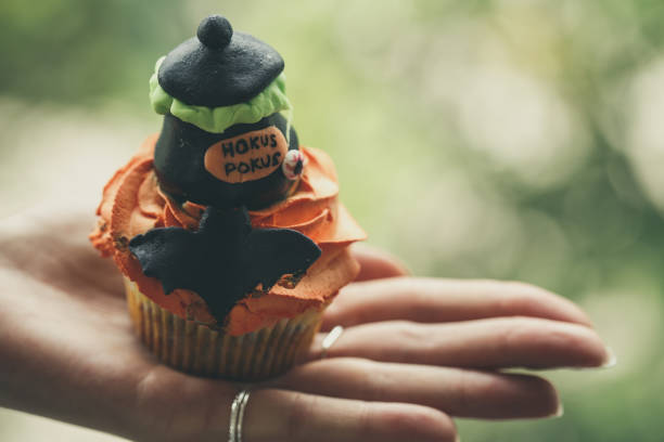istock Woman holding Halloween cupcake 1184386210