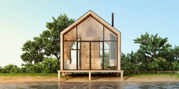 istock A small minimalist modern house in Scandinavian style with large panoramic Windows and wood trim on the waterfront. 3D illustration. 1184386322