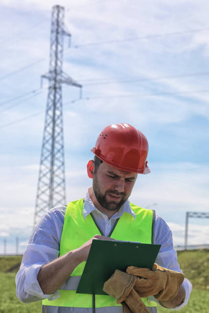 istock Electrician working in a helmet wearing gloves 1184386369