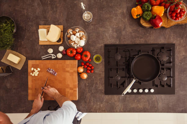 istock Man chopping onion on a cutting board 1184387137