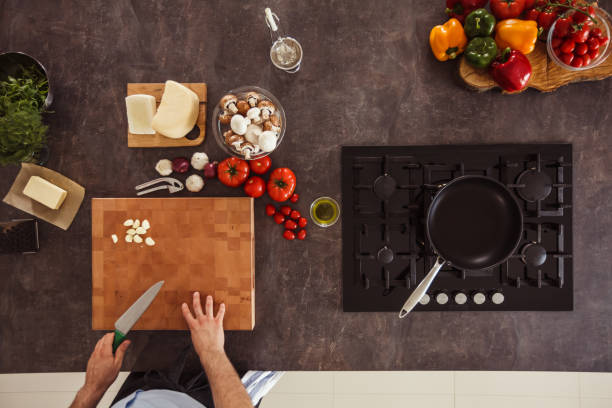 istock Unrecognizable man preparing to chop garlic on a cutting board 1184387147