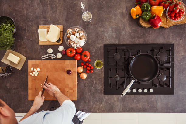 istock Unrecognizable man chopping an onion on a cutting board 1184387153