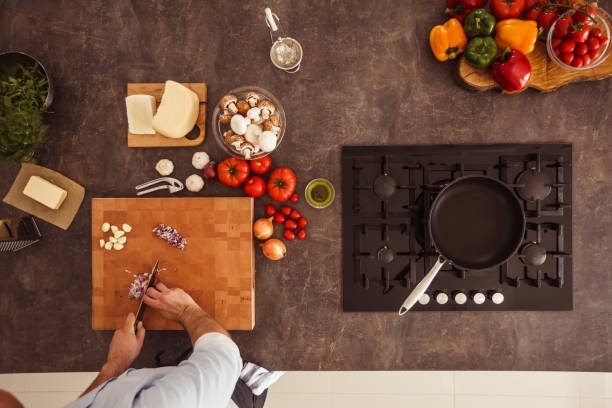 Man cutting up onion for a dish he is making