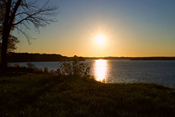istock Sun setting over Belmont Bay with silhouette of trees and cliff 1184387275
