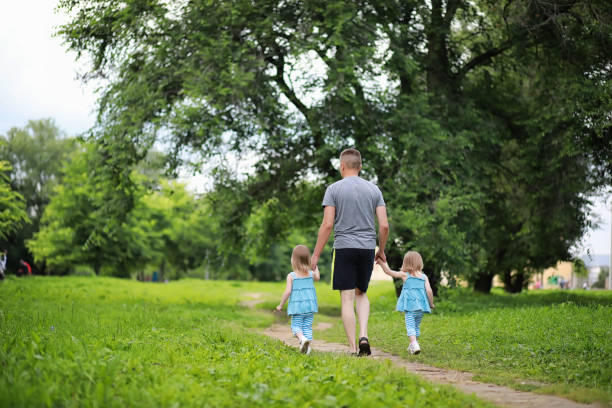 istock Mom with two daughters twins 1184387597