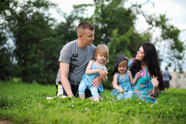 istock Mom with two daughters twins 1184388273