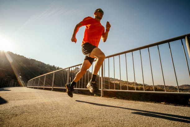 istock Man running on the bridge in nature 1184389237