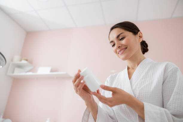 istock Cheerful pretty lady holding bottle of vitamins 1184389252