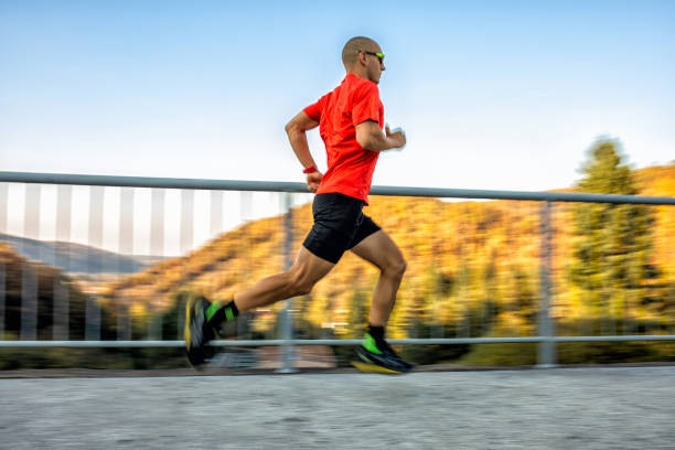 istock Man running on the bridge in nature 1184389655
