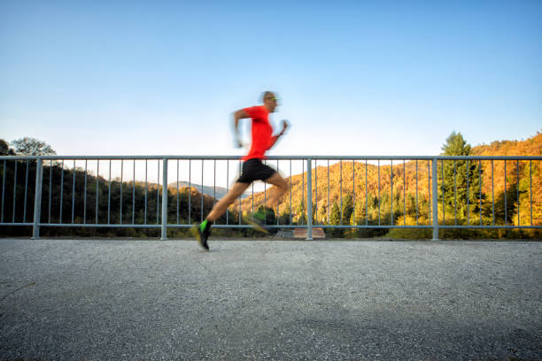 istock Man running on the bridge in nature 1184389662