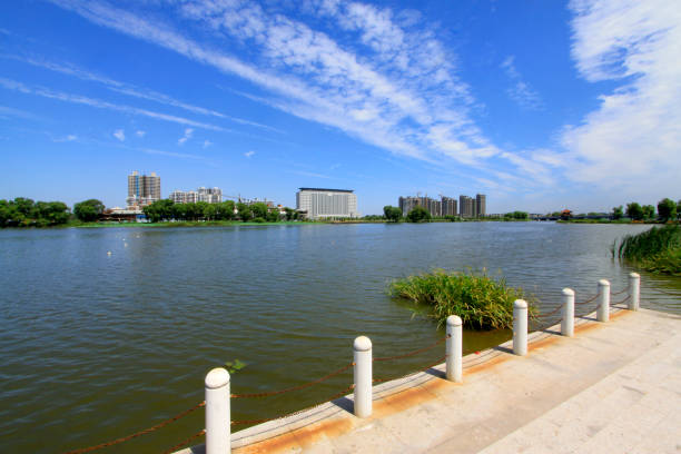 istock Wide water surface and buildings in a park 1184389796