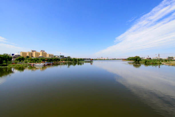 istock Wide water surface and buildings in a park 1184389810
