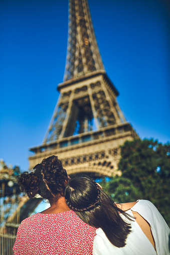 Rearview shot of two young women admiring The Eiffel Tower at a carnival