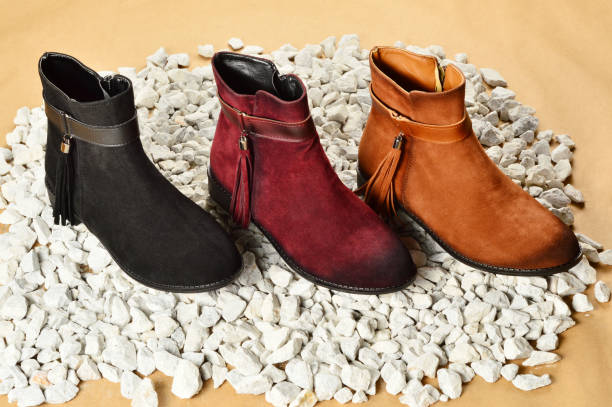 istock Women's Boots on the Pebbles 1184393160