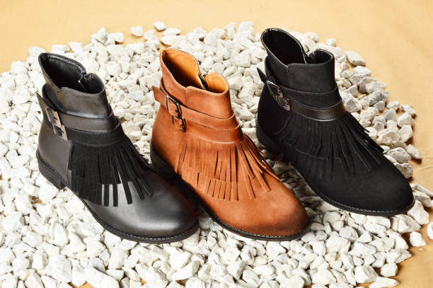 istock Women’s Boots on the Pebbles 1184393468