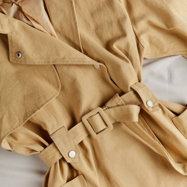 beige color is into fashion in this season beige color is into fashion in this season, top view photo. woman has left her jacket on the floor coat wool button clothing stock pictures, royalty-free photos & images