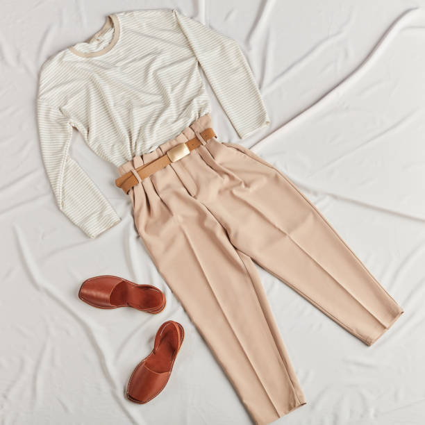 istock Modern female clothes lying on bed 1184393561