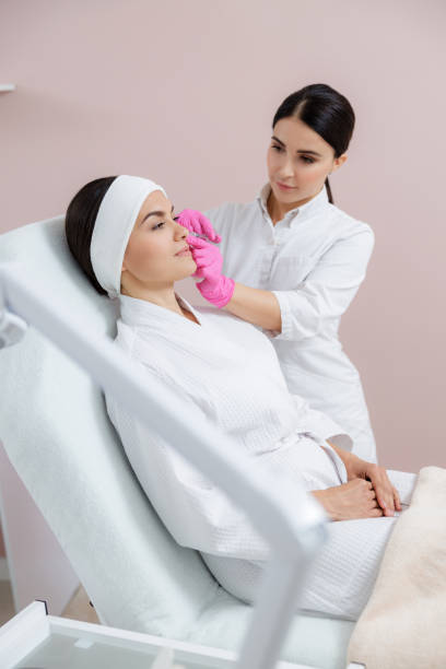 istock Smiling young woman getting beauty injection at spa salon 1184393894