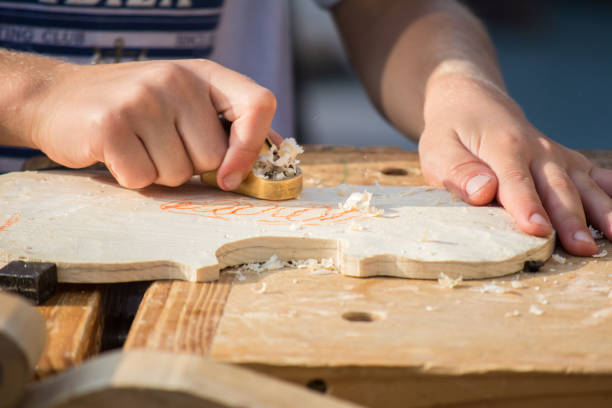 les enfants apprennent à faire du violon personnalisé et d'autres instruments de musique dans les classes de fablab en plein air. formation de joiner sur makerfaire. - fertigung photos et images de collection