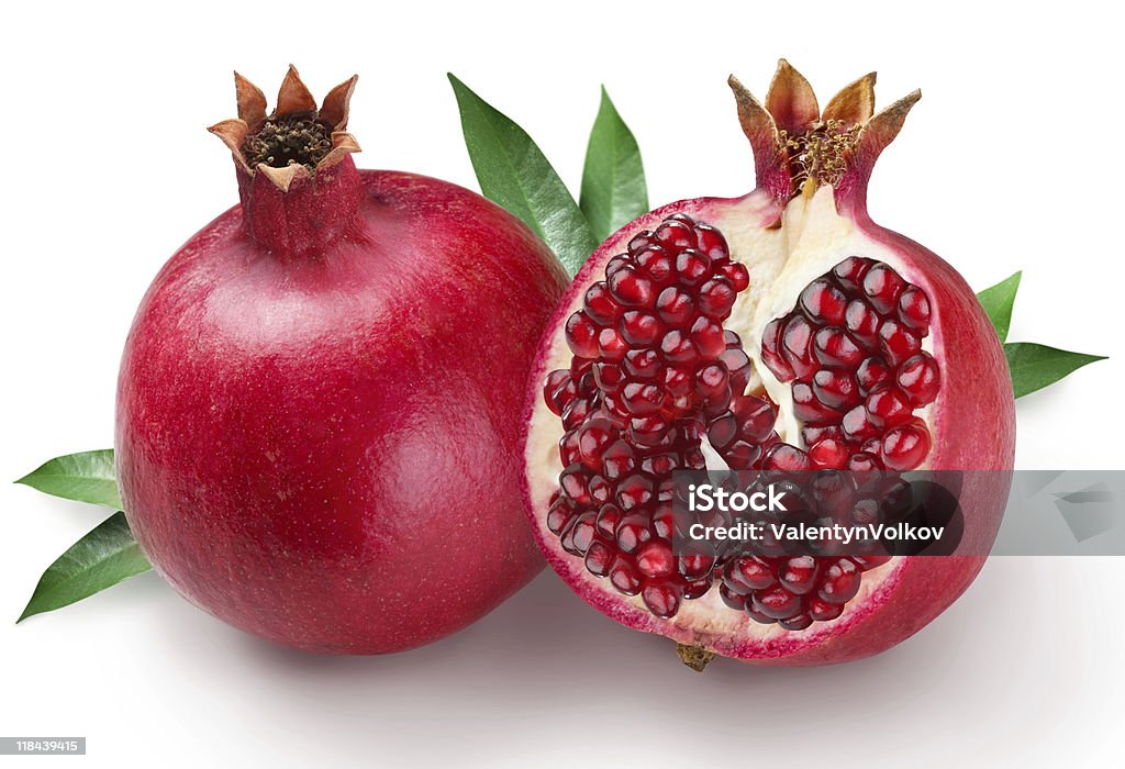 Two pomegranates one with seeds exposed pomegranates on a white background Pomegranate Stock Photo