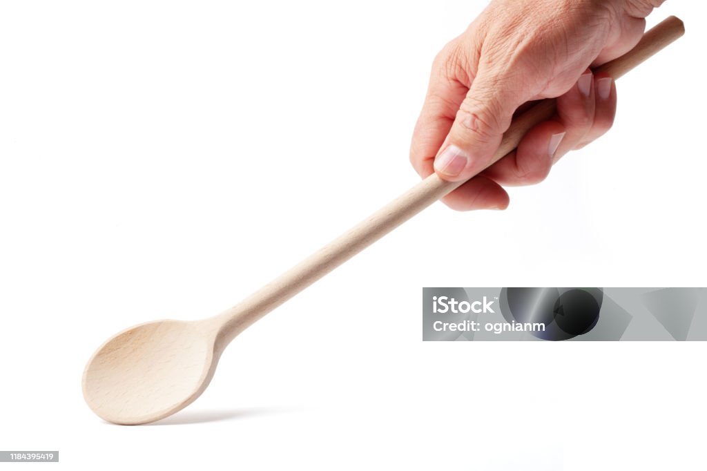 Hand with a Wooden Cooking Spoon on White Hand with a wooden cooking spoon with clipping path isolated on white background Hand Stock Photo