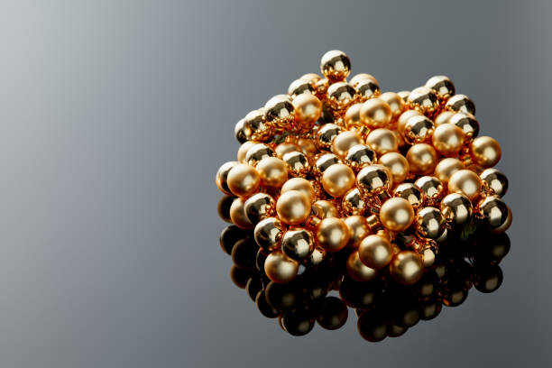 istock shiny golden Christmas decoration on grey background with reflection and copy space 1184396984