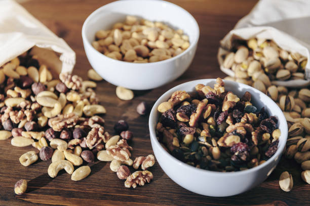 istock selection of mixed nuts in bowls and a burlap sack 1184397066