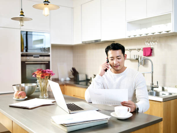 istock young asian man working at home 1184397729