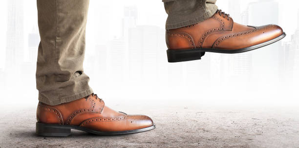istock Man takes a step in classic shoes 1184398981
