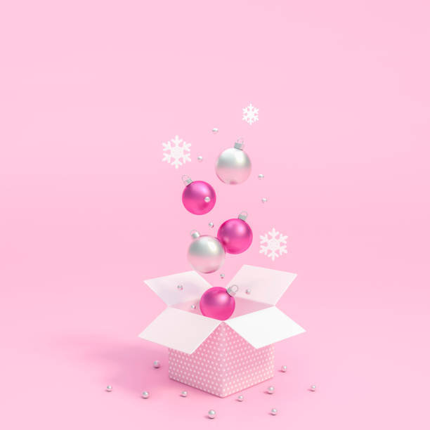 istock Metallic silver and white christmas ball Ornaments floating on gift box opening with pink background 1184398992