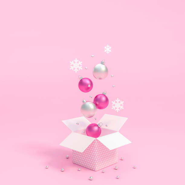 металлический серебристый и белый рождественский шар орнаменты плавающие на открытии подарочной коробки с розовым фоном - gift pink box gift box стоковые фото и изображения