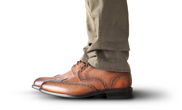 istock Man takes a step in classic shoes 1184399020