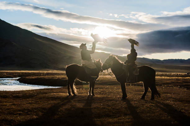 istock Portrait of two eagle hunters near the river in Mongolia 1184399059
