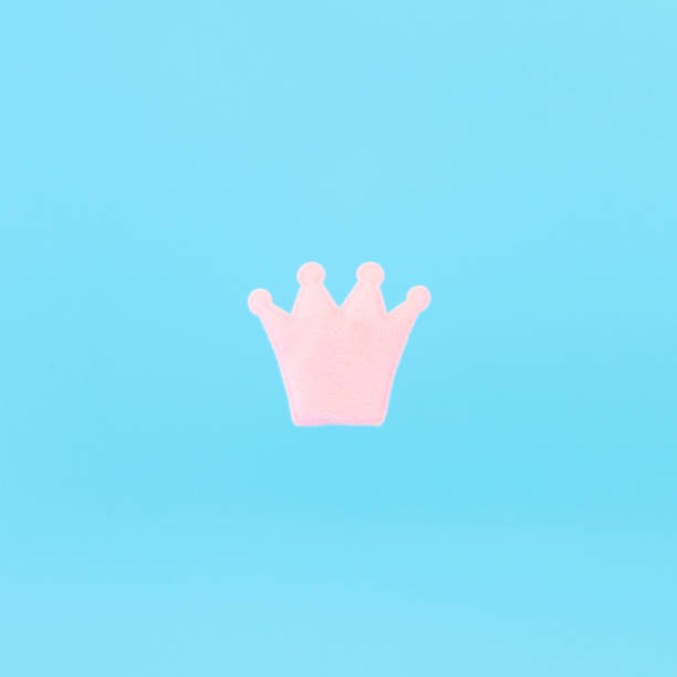 istock Pink crown on a blue background. Minimal concept photo. Avatar. 1184399083