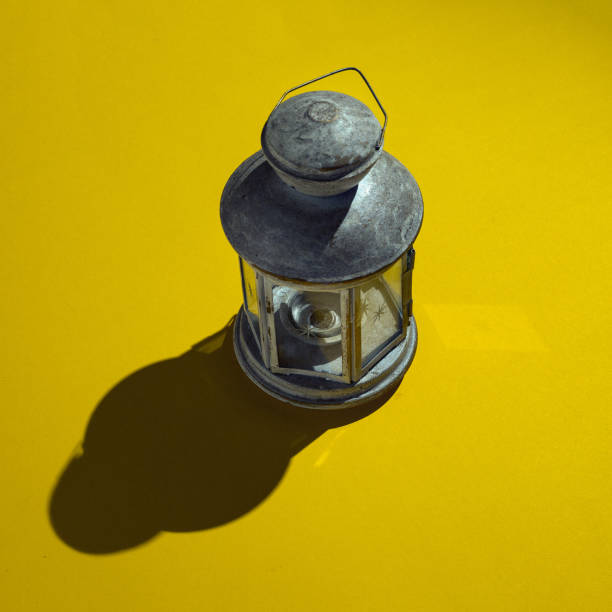 istock Old shabby white Lantern lamp on yellow background, decorative concept 1184399529