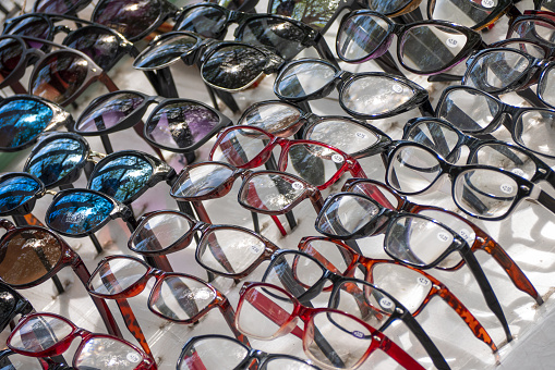 Display of counterfeit reading and sunglasses for sale on the street.
