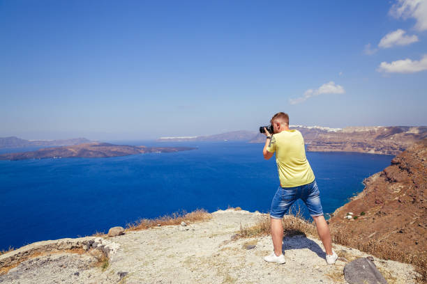 istock Young man photographs the landscape 1184402756