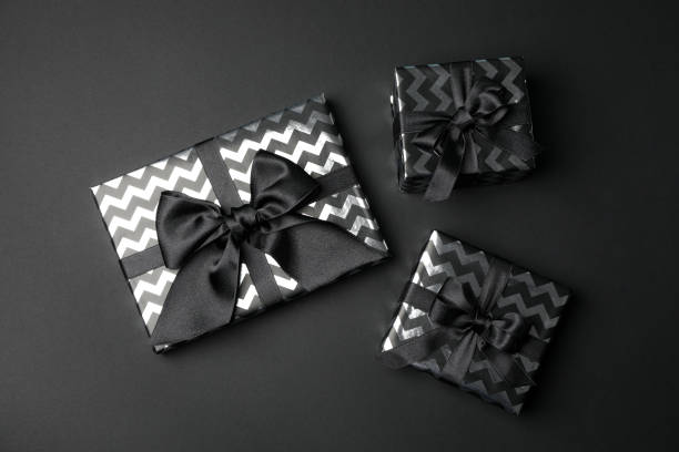 istock Gift boxes with bow on black background. Black Friday sale 1184402850