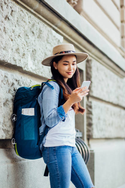 istock Beautiful Asian girl on a journey resting and texting 1184405544