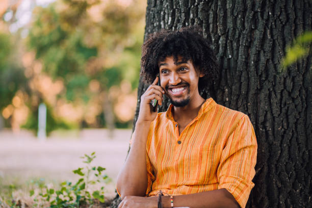 istock Handsome Afro man talking on mobile phone 1184406570