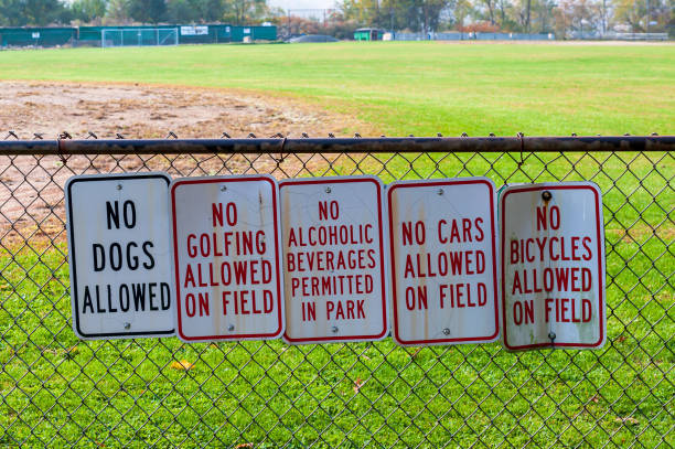 istock Signs on a chain link fence at a baseball field 1184409052