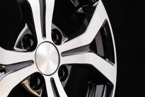 istock new cast aluminum wheel disc close up on black background. forked spokes, black and polished surface 1184409210