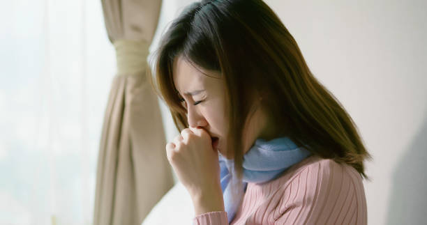 asian woman cough in bedroom asian woman sick and cough in the bedroomasian woman sick and sneeze with tissue paper in the bedroom bed of hay stock pictures, royalty-free photos & images
